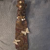 Brown tie necklace with leaf details from the current Facebook drop.